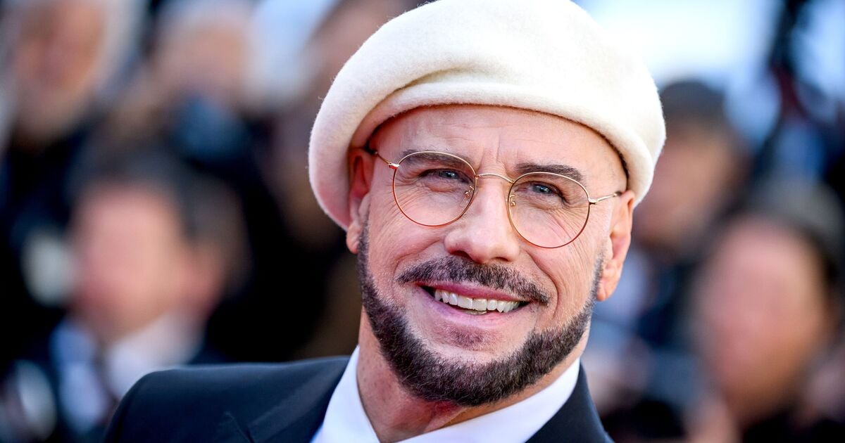John Travolta Explains His Bold Cannes Headgear Choice